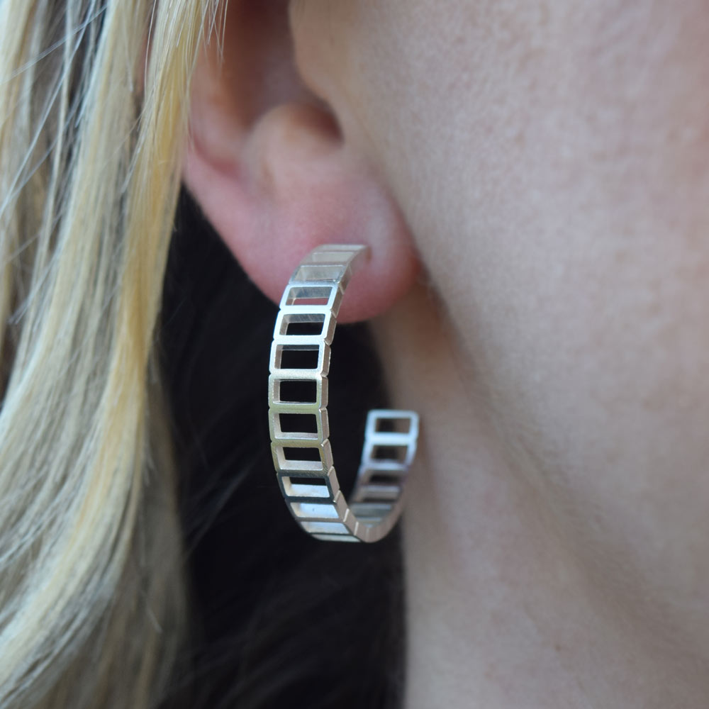 Brickwork pattern large hoop earrings being worn on the ear