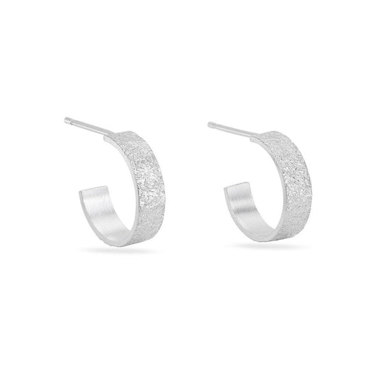 A pair of silver mini textured hoop earrings against a white background.