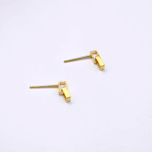A pair of gold-colored mini brickwork drop stud earrings on a white background.